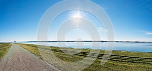 Asphalt walk along bank of Gabcikovo Dam on sunny day - panoramic