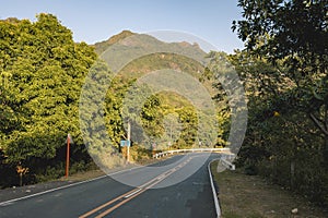 An asphalted 2 lane highway, with Mt. Pico de Loro in the background. Near the boundary of Ternate, Cavite and Nasugbu, Batangas