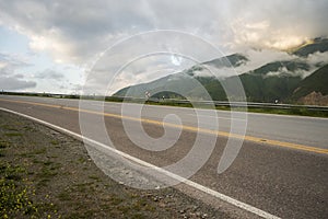 asphalted road that ascends between the mountains