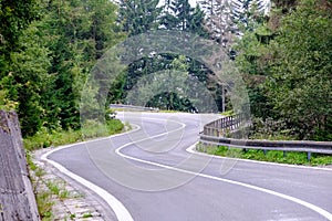 Asphalted road leading up to the mountains in forest