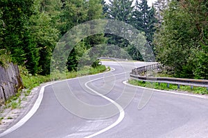 Asphalted road leading up to the mountains in forest