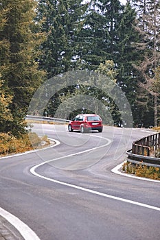 Asphalted road leading up to the mountains in forest - vintage r