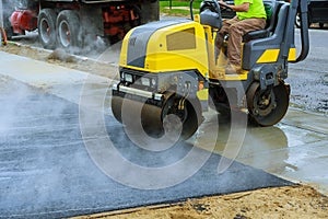 Asphalting construction works with commercial repair equipment road crews