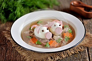 Aspic with meat, pork jelly is a festive traditional Russian dish decorated with boiled eggs in the form of cute pigs.