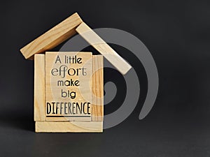 Aspiration concept - a little effort make big difference text written on wooden surface background. Stock photo.