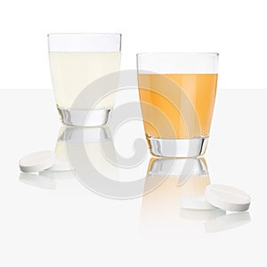 Aspirin tablets and glass isolated on table, orange and lemon vitamin c, cold and flu cure concept