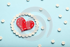 Aspirin tablets and red heart. Cardiology and medicine, healthcare and pharmacy concept