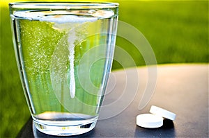 Aspirine pill into water photo
