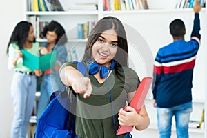 Aspiring spanish female student with group of students