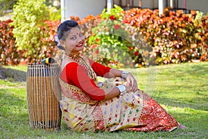 Assamese girl In traditional attire posing with A Dhol, Pune, Maharashtra.