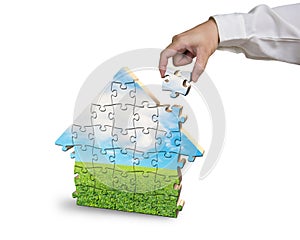 Assembling house shape puzzles in beautiful landscape