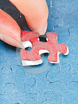 Assembling the last red piece of puzzle