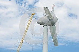 Assembling wings Dutch windturbine with large crane