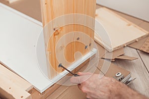 Assembling wooden furniture manually with screwdriwer
