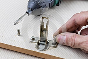 Assembly of hinges in a carpentry workshop. Joinery accessories