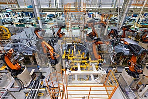 assembly line in a car factory, welding with robots, automated work