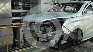 Assembly of modern automobiles for people, car body is moving in workshop