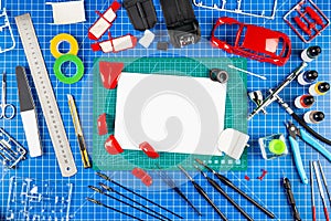 Assembly and painting of a red retro scale model car vehicle concept copy space background. modeling tools airbrush gun paint kit