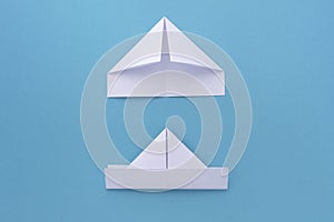 Assembly procedure for a white paper ship. Origami