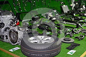Assembly set of details of the car are spread out on a green surface. Assembly shop of the automobile enterprise
