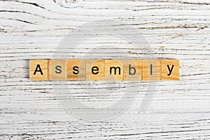 ASSEMBLY word made with wooden blocks concept