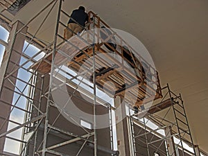 assembly works on the installation of industrial air conditioning, a large refrigerating warehouse. A worker in the