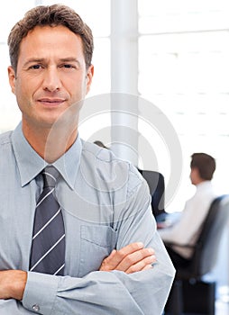 Assertive businessman standing in front of his tea