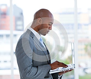 Assertive businessman working at a laptop