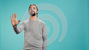 Assertive man doing stop hand gesture sign photo