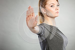 Assertive woman making stop gesture.