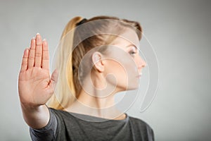 Assertive woman making stop gesture.