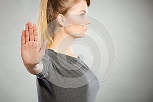 Assertive woman making stop gesture.