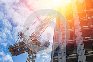 Asset development concept. Crain with under construction building.