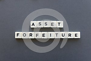 Asset forfeiture word made of square letter word on grey background.