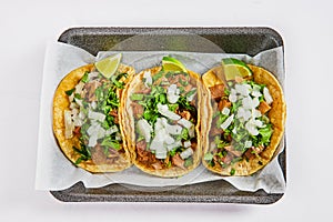 Asset three lengua cow tongue street tacos with lime wedges photo