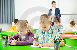 Assiduous kids studying in classroom
