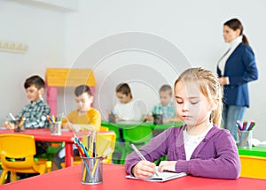 Assiduous little girl at lesson