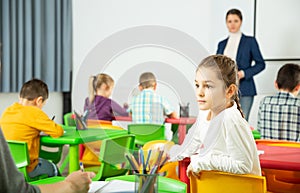 Assiduous schoolgirl at lesson