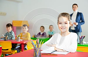 Assiduous schoolgirl at lesson