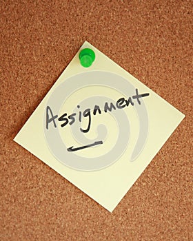 Assignment witten on note stuck to corkboard