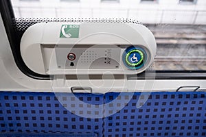 assistance button for passengers with reduced mobility in metro trains, communication with driver in Germany, concept of long-