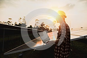 Assistance technical worker in uniform is checking an operation and efficiency performance of photovoltaic solar panels