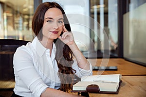 Assistant attorney young law student taking notes in notepad at office workplace, modern businesswoman portrait
