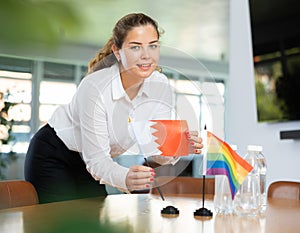 Young lady sets miniatures flags of LGBT and Bahrein before international negotiations photo
