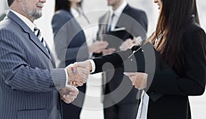 Assistant meets a businessman with a handshake. meetings and partnership