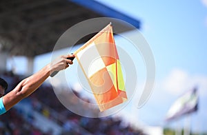 Assistant referee hold flag , offside signal