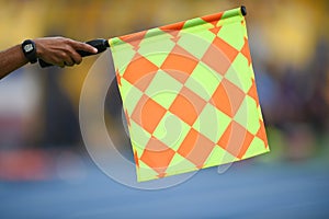 Assistant referee hold flag , offside signal