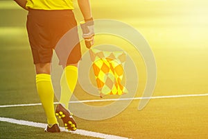 Assistant referee moving along the sideline during a soccer match