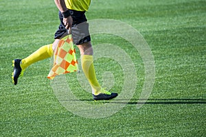 Assistant referee moving along the sideline during a soccer match