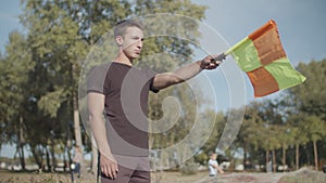 Assistant referee raising flag for offside trap